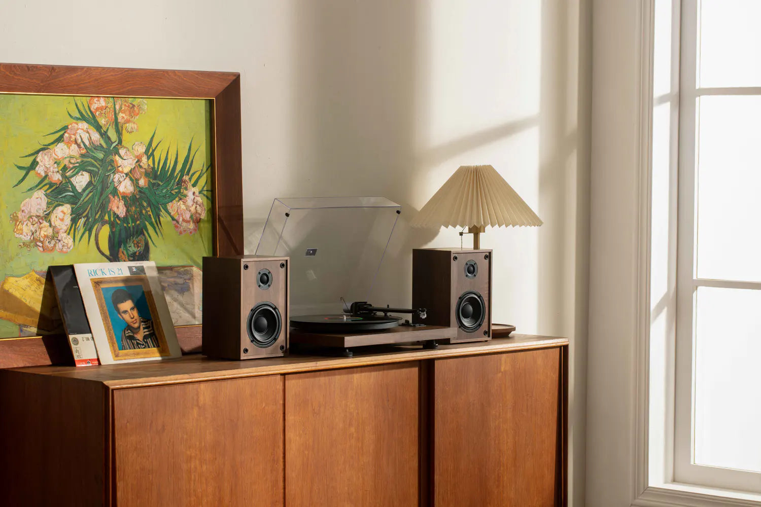 Warm sunlit room showcasing the best vinyl record player on a cabinet, acting as a record player with speakers.