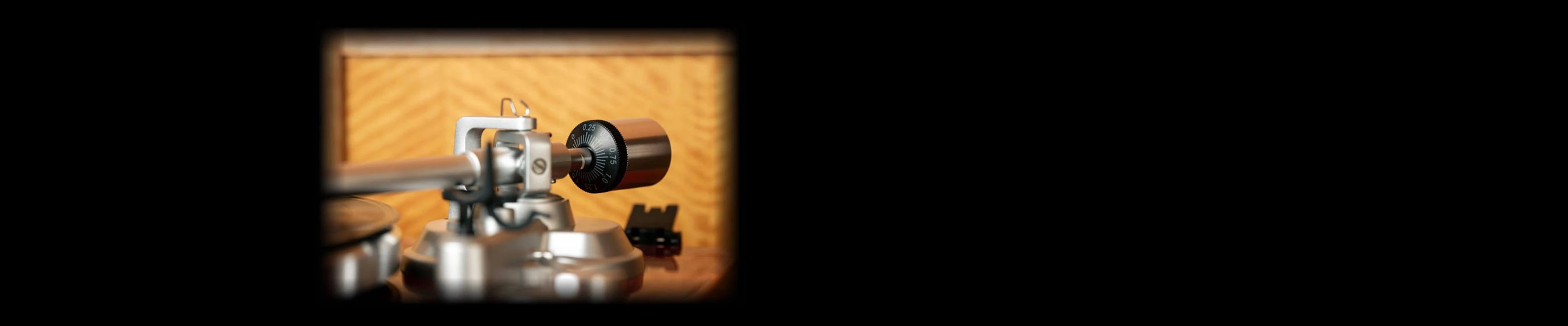 Close-up of a high-fidelity turntable tonearm with counterweight adjustment.