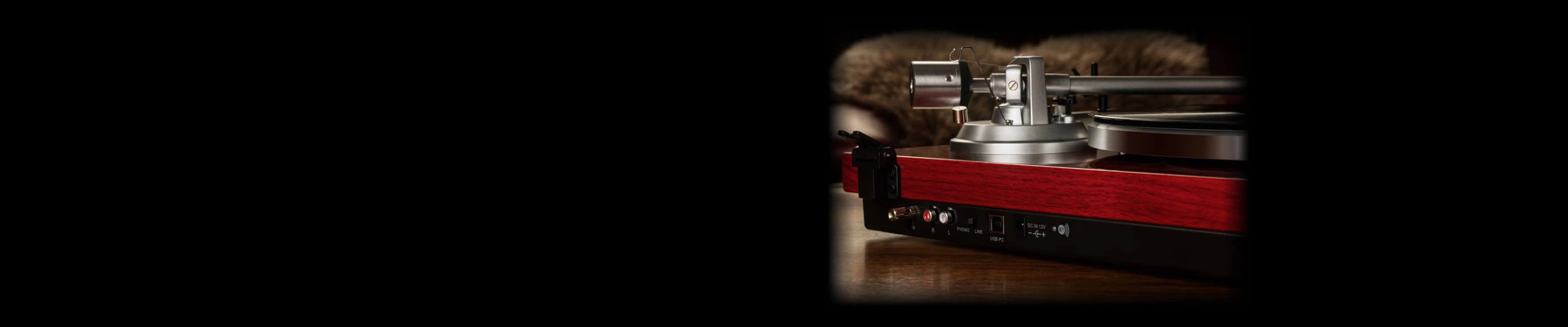 Rear view of a mahogany vinyl turntable player showing RCA output port