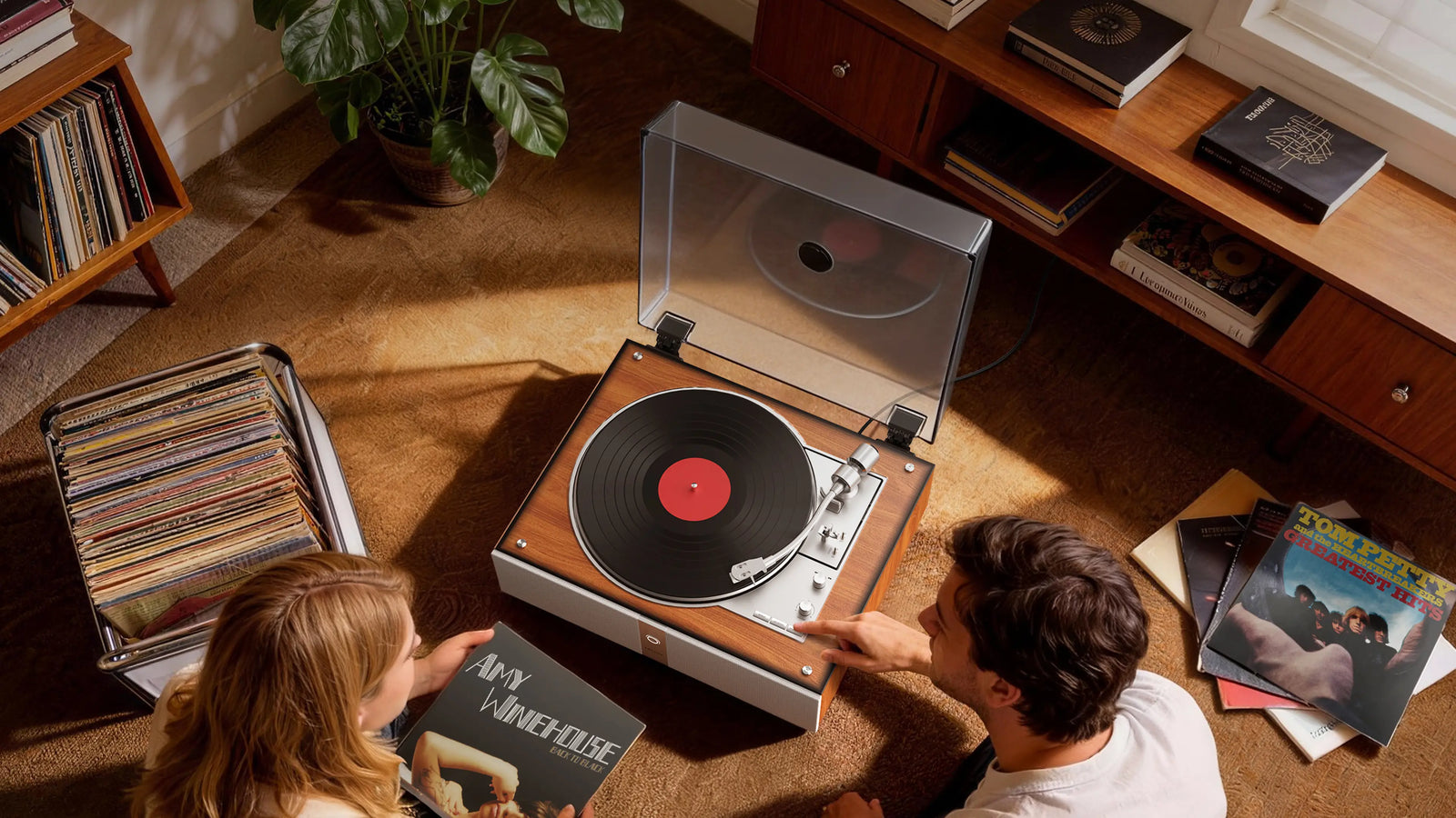 A couple enjoying a fully automatic record player in a sunlit living room