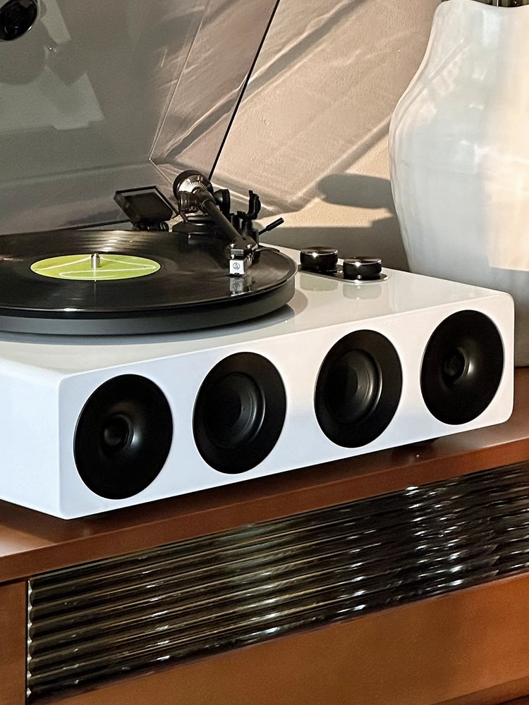 Front view of a white record player with built-in speakers.