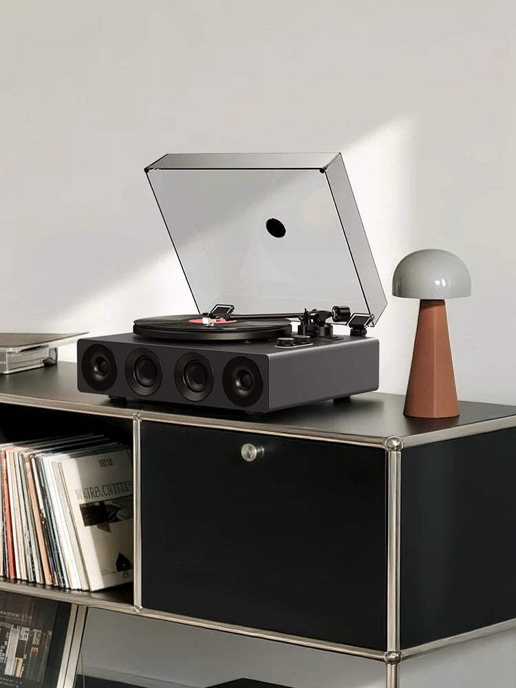 Grey all-in-one record player on a black modular cabinet with vinyl storage.