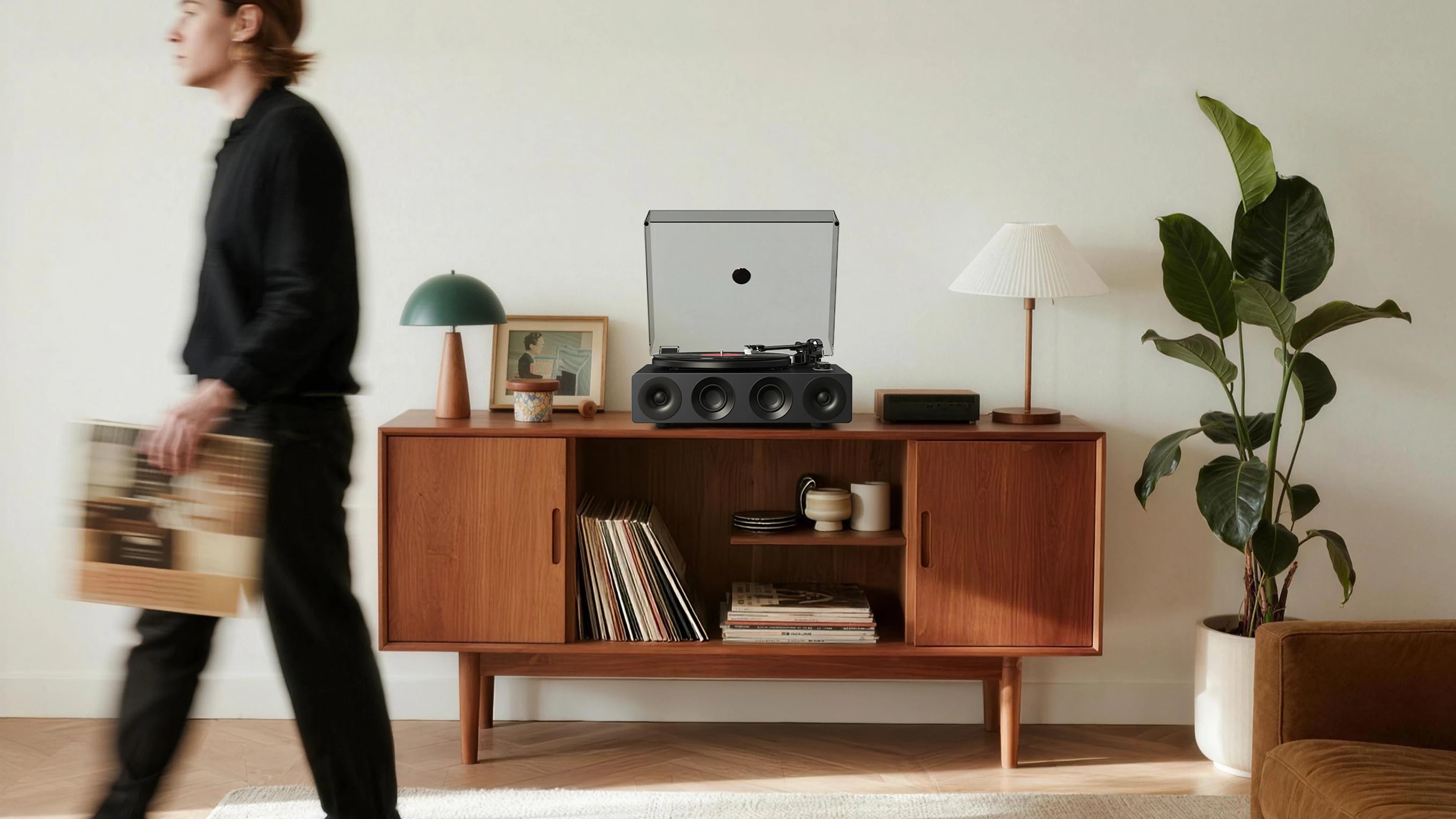 Modern all-in-one record player on a walnut mid-century sideboard with album storage in a living room