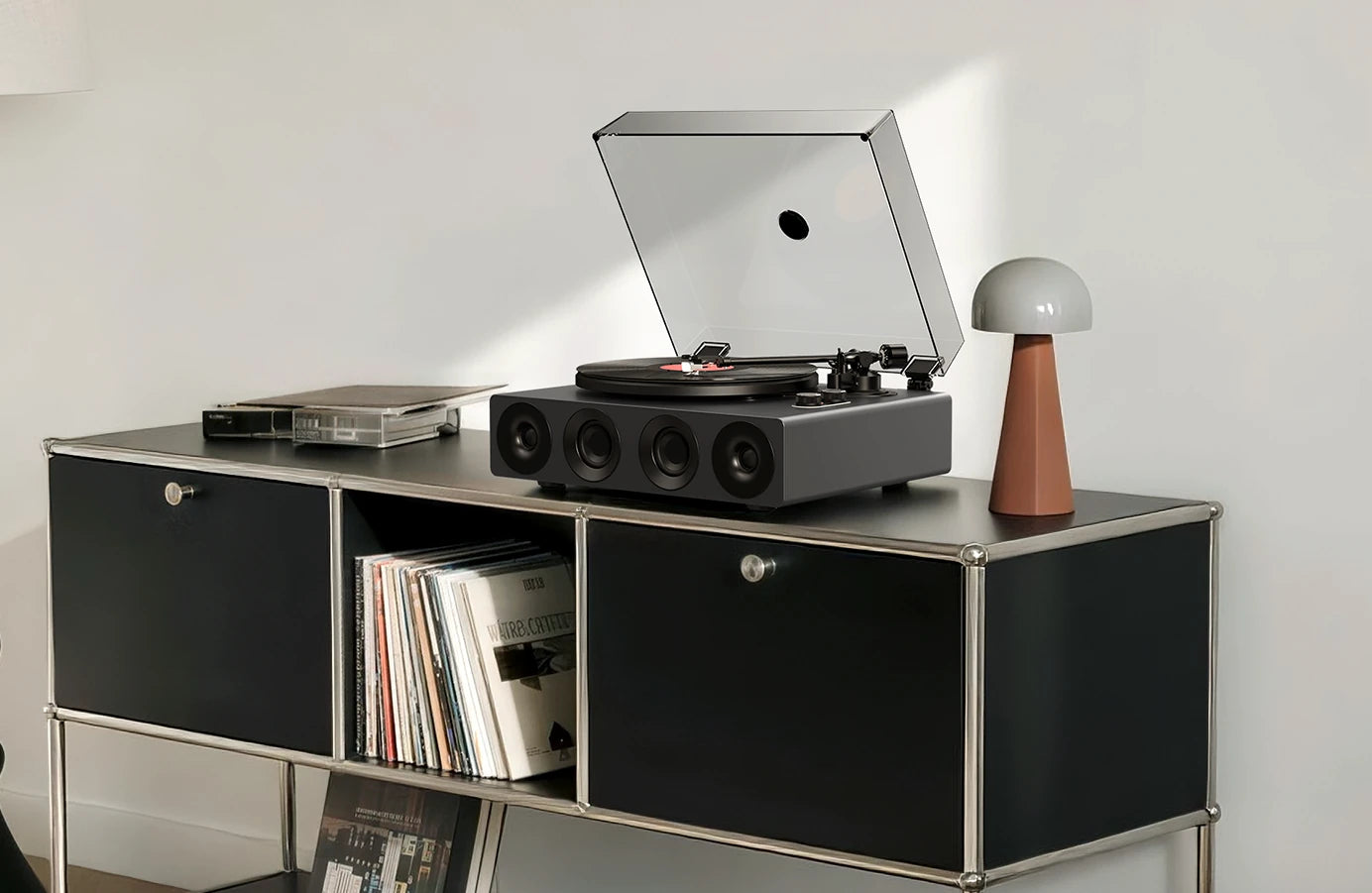 Grey all-in-one record player on a black modular cabinet with vinyl storage.