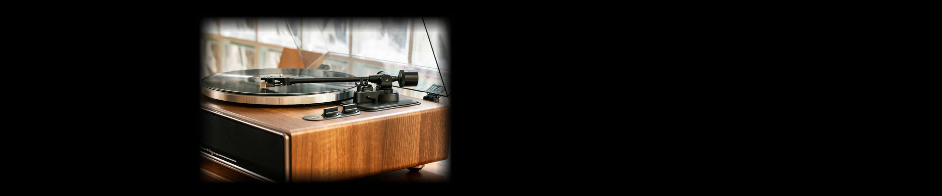 Close-up highlighting the tonearm and stylus of a high fidelity record player.
