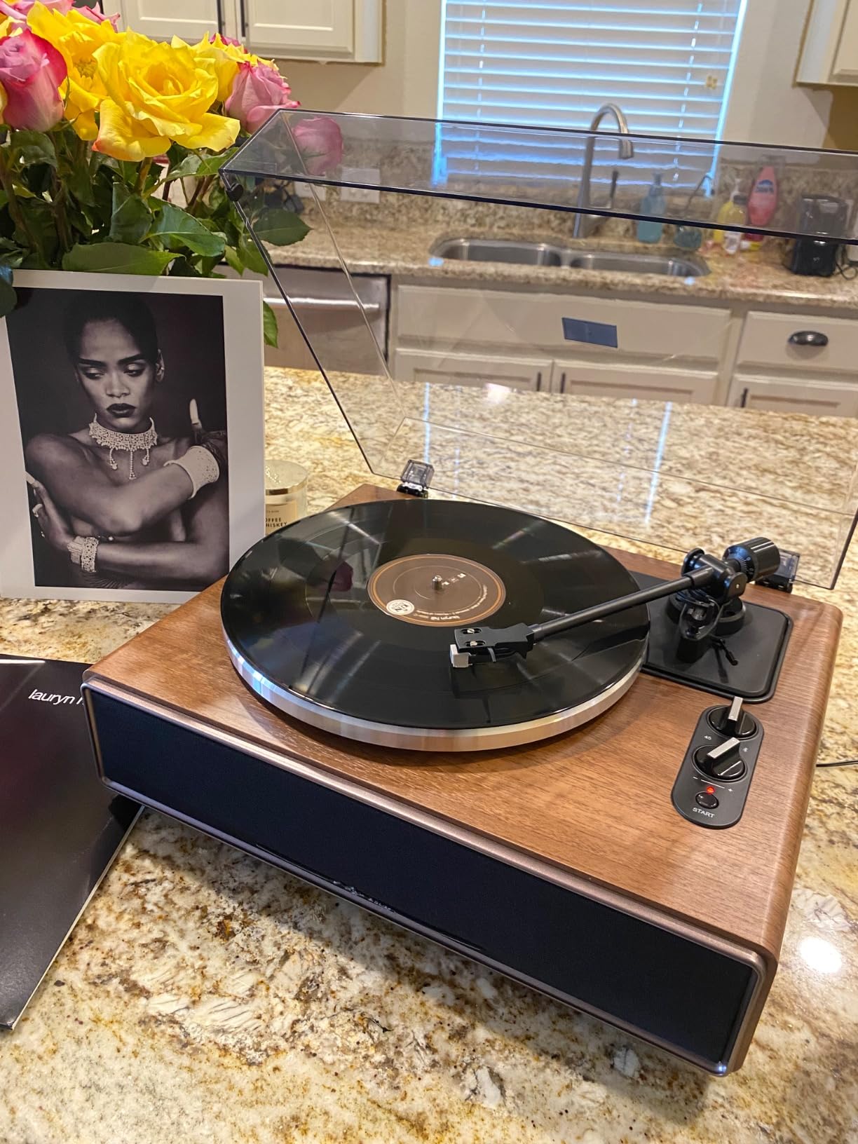 Walnut Manual record player all in one on a marble kitchen island.